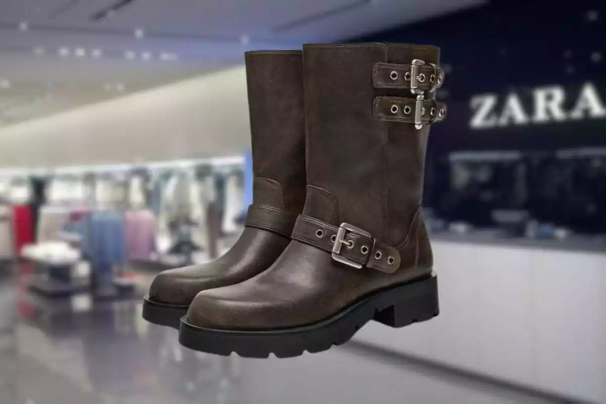 Foto en primer término de unas botas estilo biker de efecto envejecido con tienda Zara de fondo desenfocada Foto en primer término de unas botas estilo biker de efecto envejecido con tienda Zara de fondo desenfocada